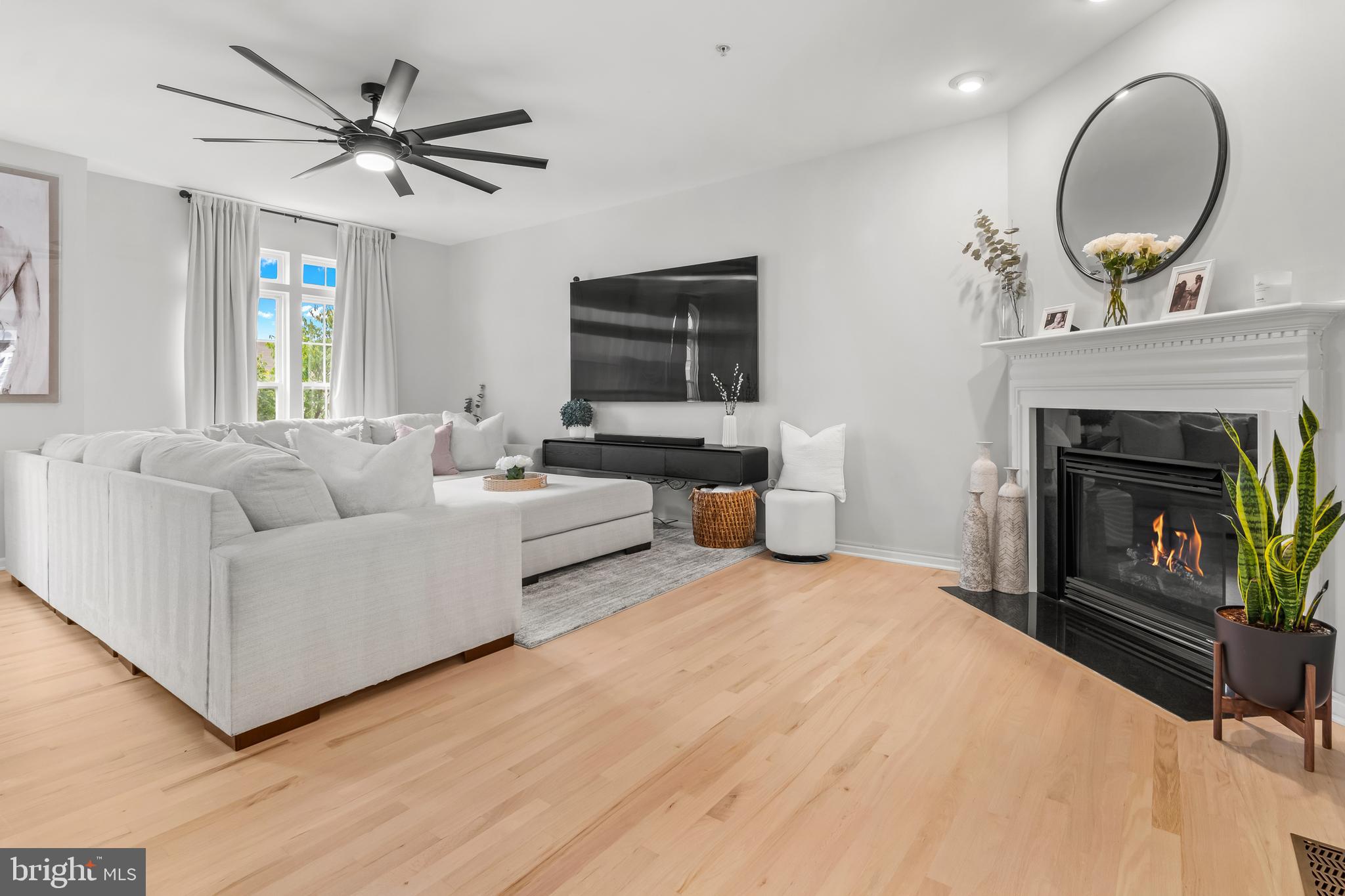 1750 Theale Way Hanover, MD 21076 - Photo 22 of 42 a living room with furniture a fireplace and a flat screen tv