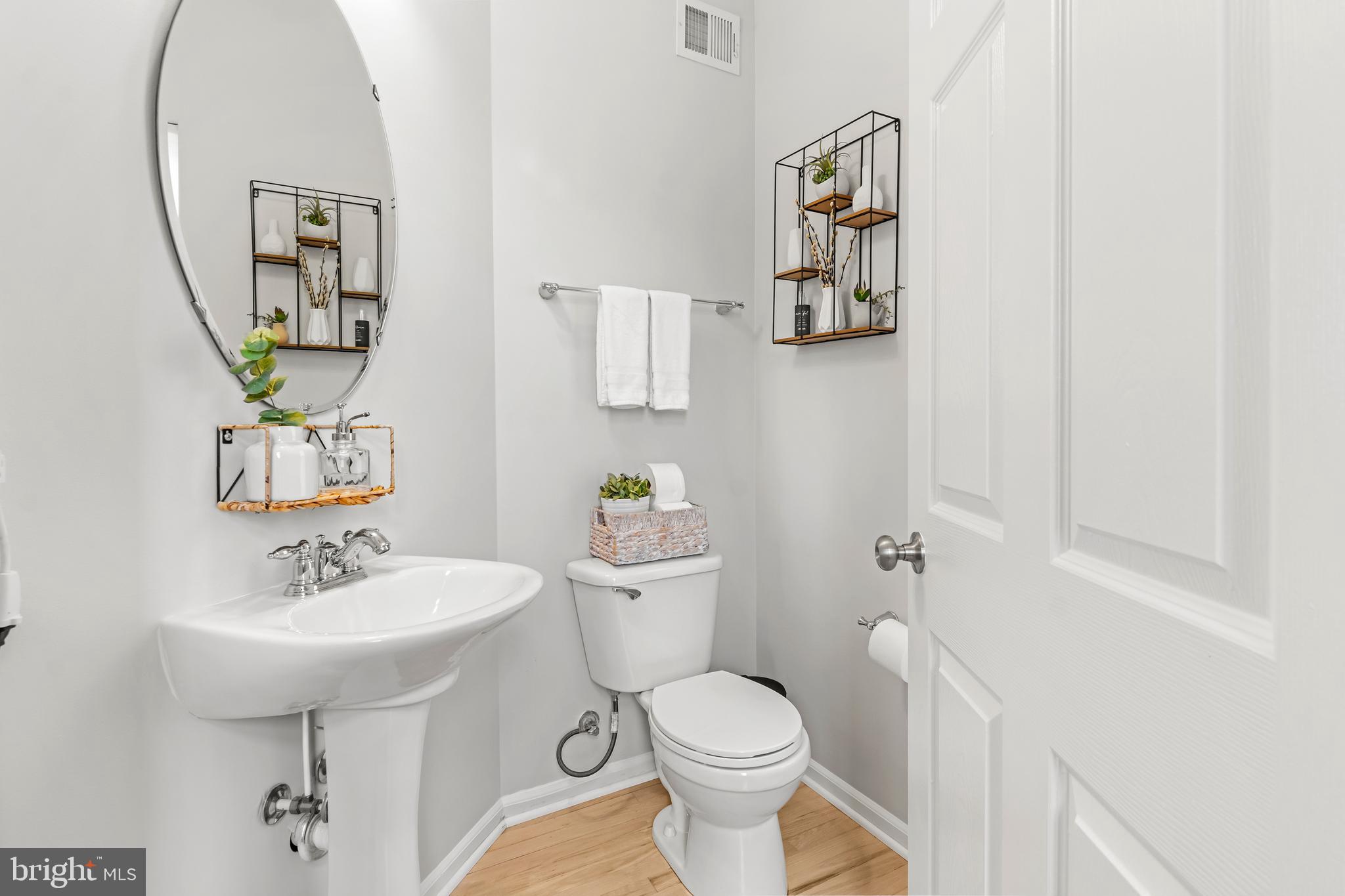 1750 Theale Way Hanover, MD 21076 - Photo 27 of 42 a bathroom with a toilet sink and mirror