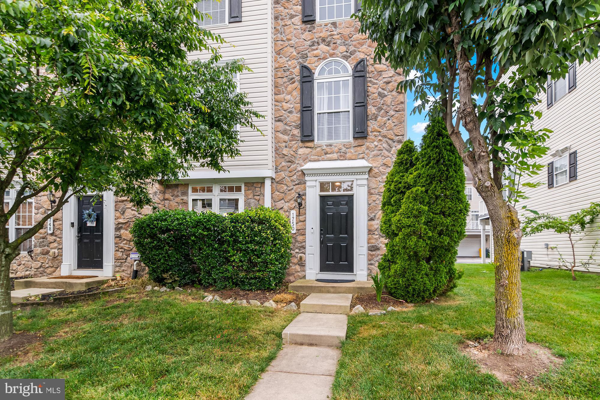1750 Theale Way Hanover, MD 21076 - Photo 3 of 42 a front view of a house with a garden