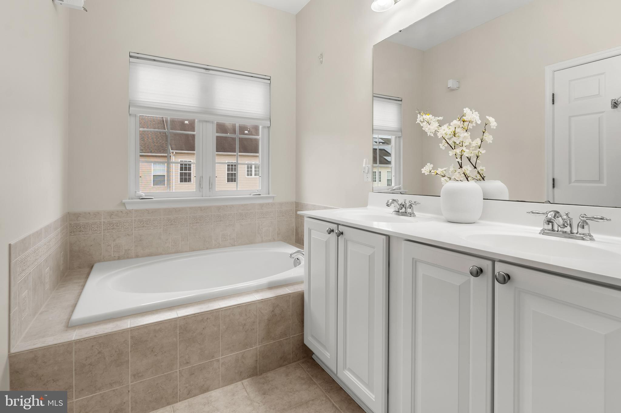 1750 Theale Way Hanover, MD 21076 - Photo 34 of 42 a bathroom with a tub sink and mirror