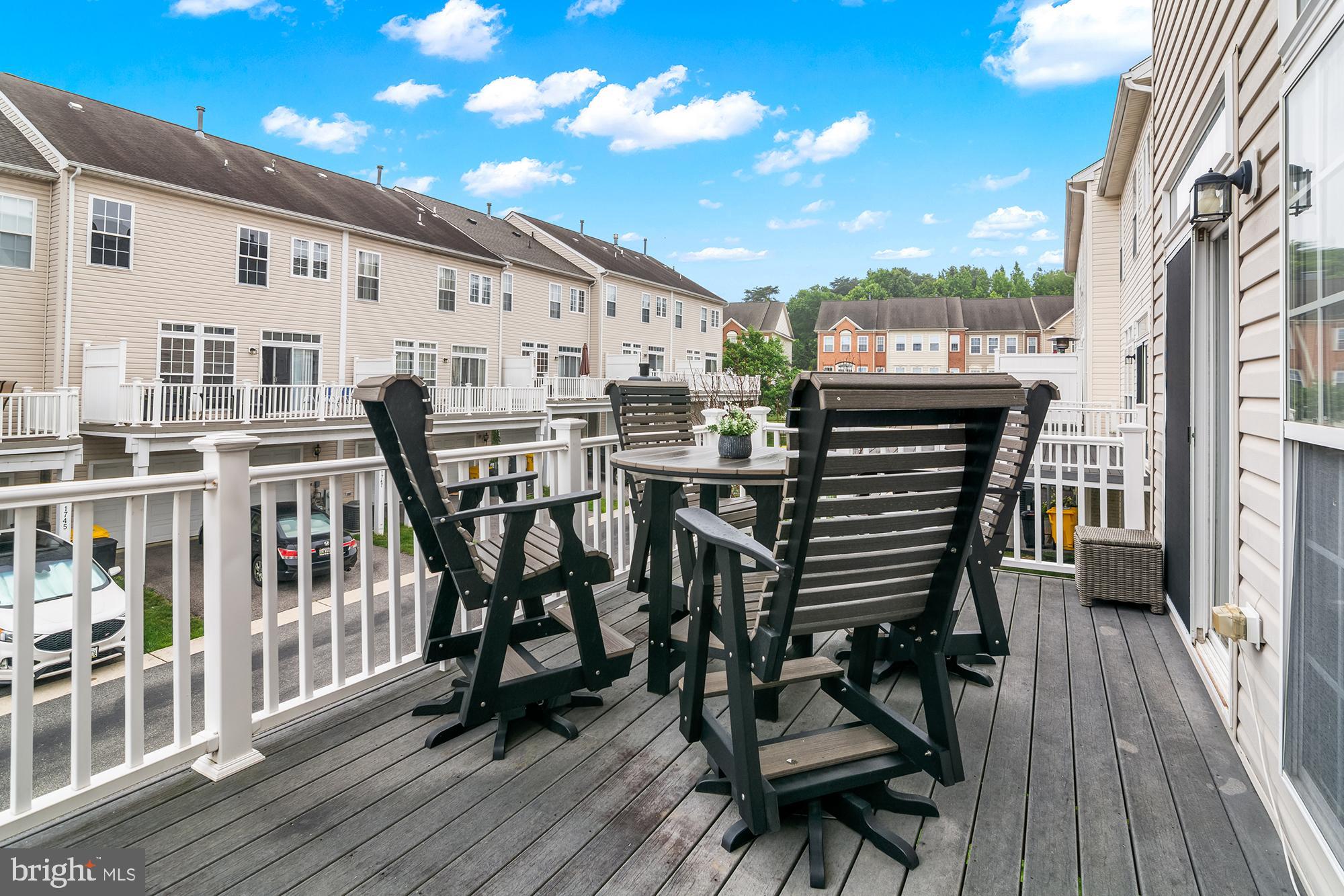 1750 Theale Way Hanover, MD 21076 - Photo 41 of 42 a view of a patio with table and chairs with wooden floor and fence