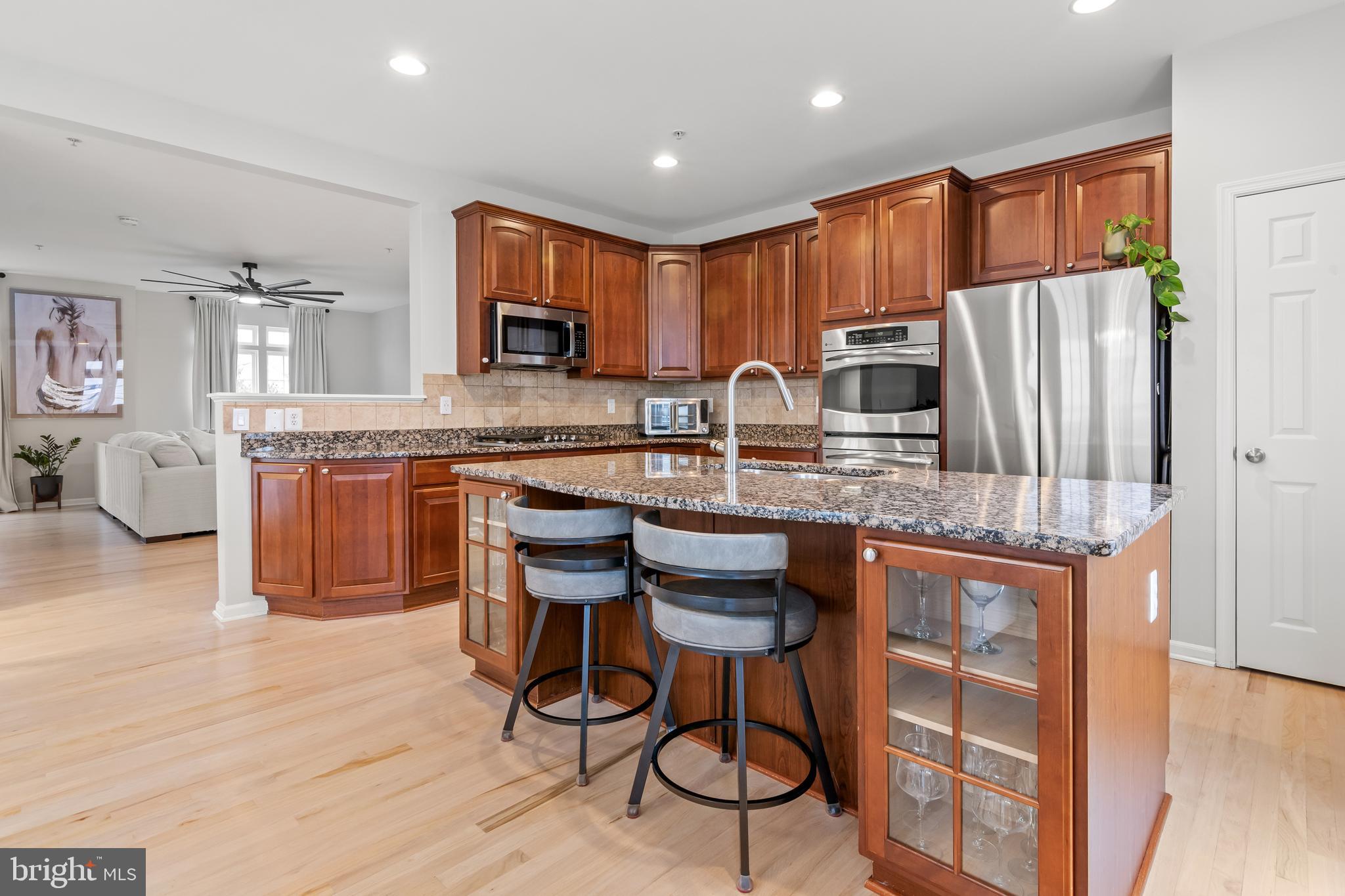 1750 Theale Way Hanover, MD 21076 - Photo 10 of 42 a kitchen with kitchen island granite countertop wooden cabinets and stainless steel appliances