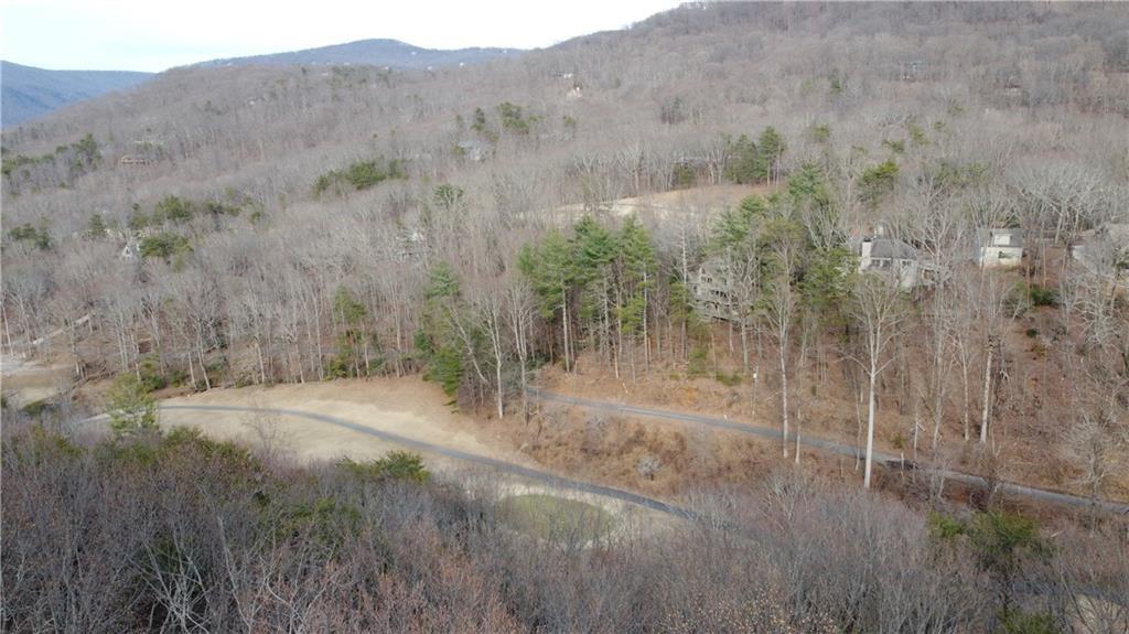 0 Mulligan Way Jasper, GA 30143 - Photo 1 of 7 a view of a dry yard with trees in the background