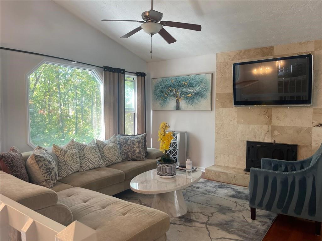 5421 Burdett Road Southeast Mableton, GA 30126 - Photo 15 of 51 a living room with furniture a flat screen tv and a fireplace