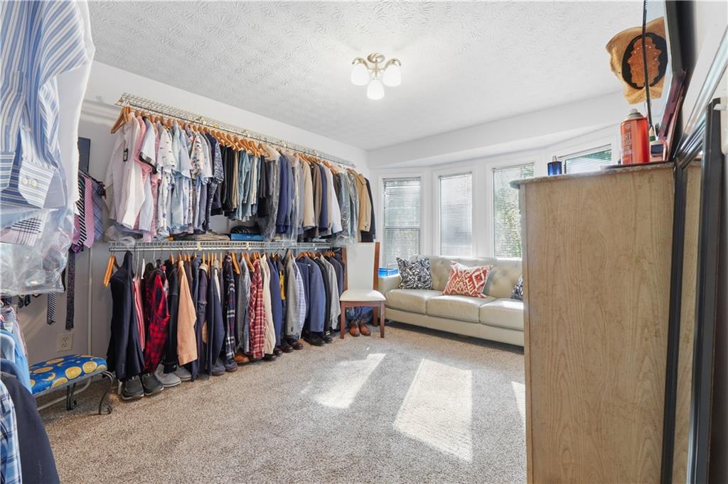 5421 Burdett Road Southeast Mableton, GA 30126 - Photo 26 of 51 a view of walk in closet with clothes and shoes