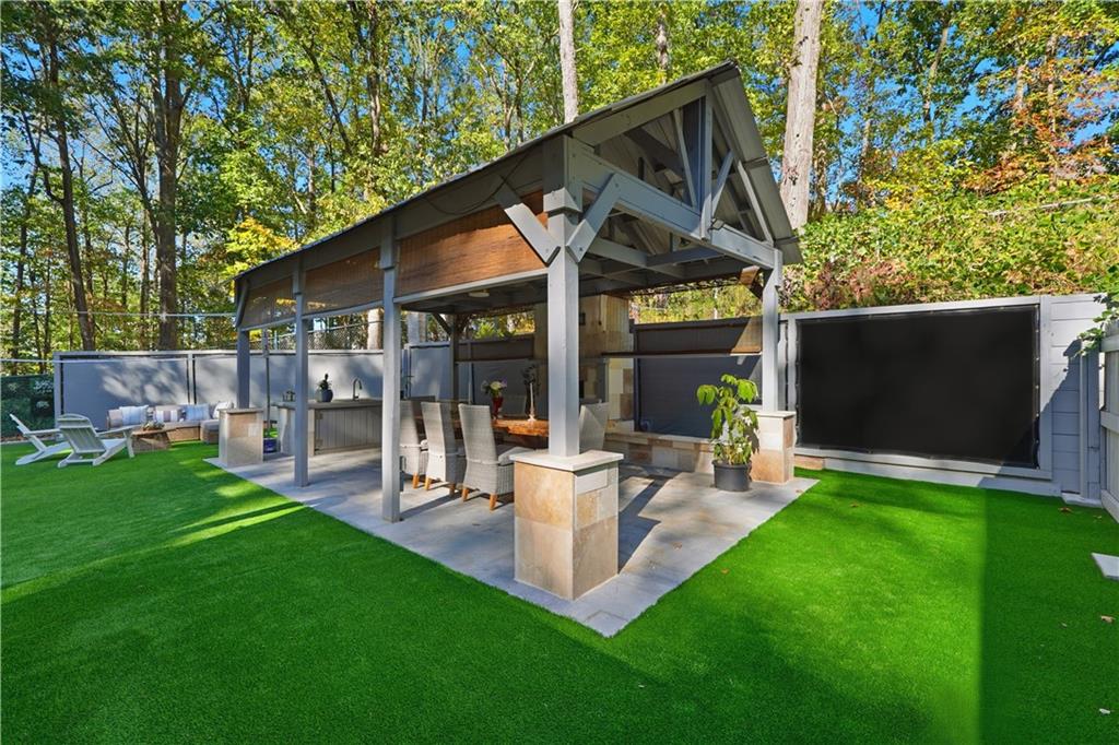 5421 Burdett Road Southeast Mableton, GA 30126 - Photo 37 of 51 a view of a patio with table and chairs potted plants and large tree