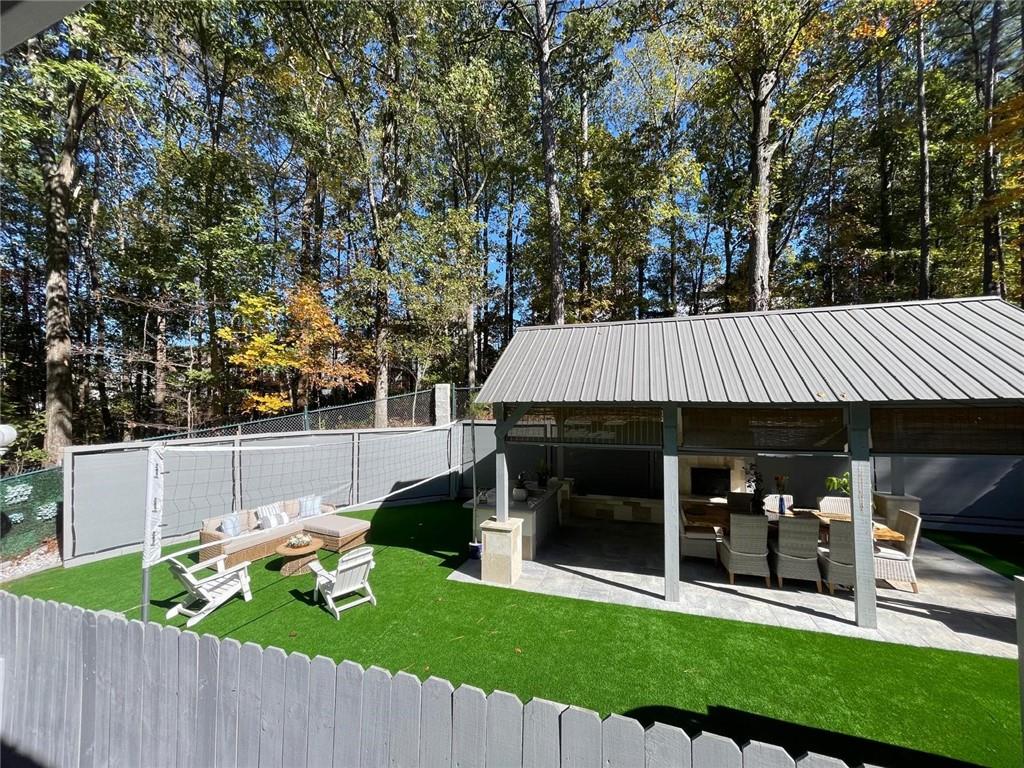 5421 Burdett Road Southeast Mableton, GA 30126 - Photo 38 of 51 a view of a patio with table and chairs potted plants and large tree