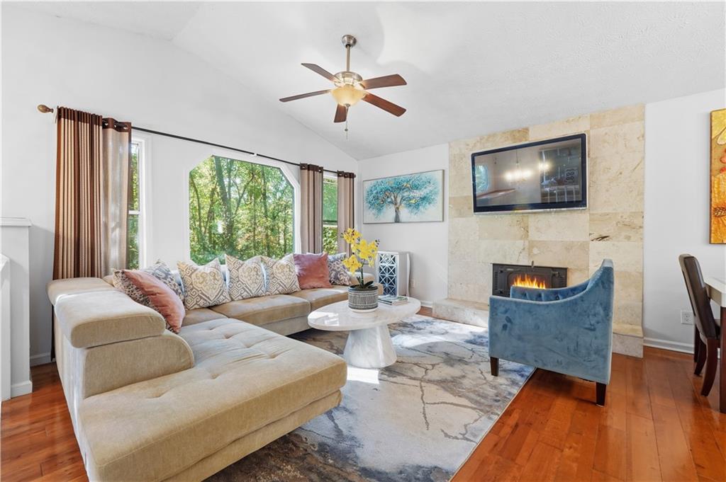 5421 Burdett Road Southeast Mableton, GA 30126 - Photo 4 of 51 a living room with furniture a flat screen tv and a large window