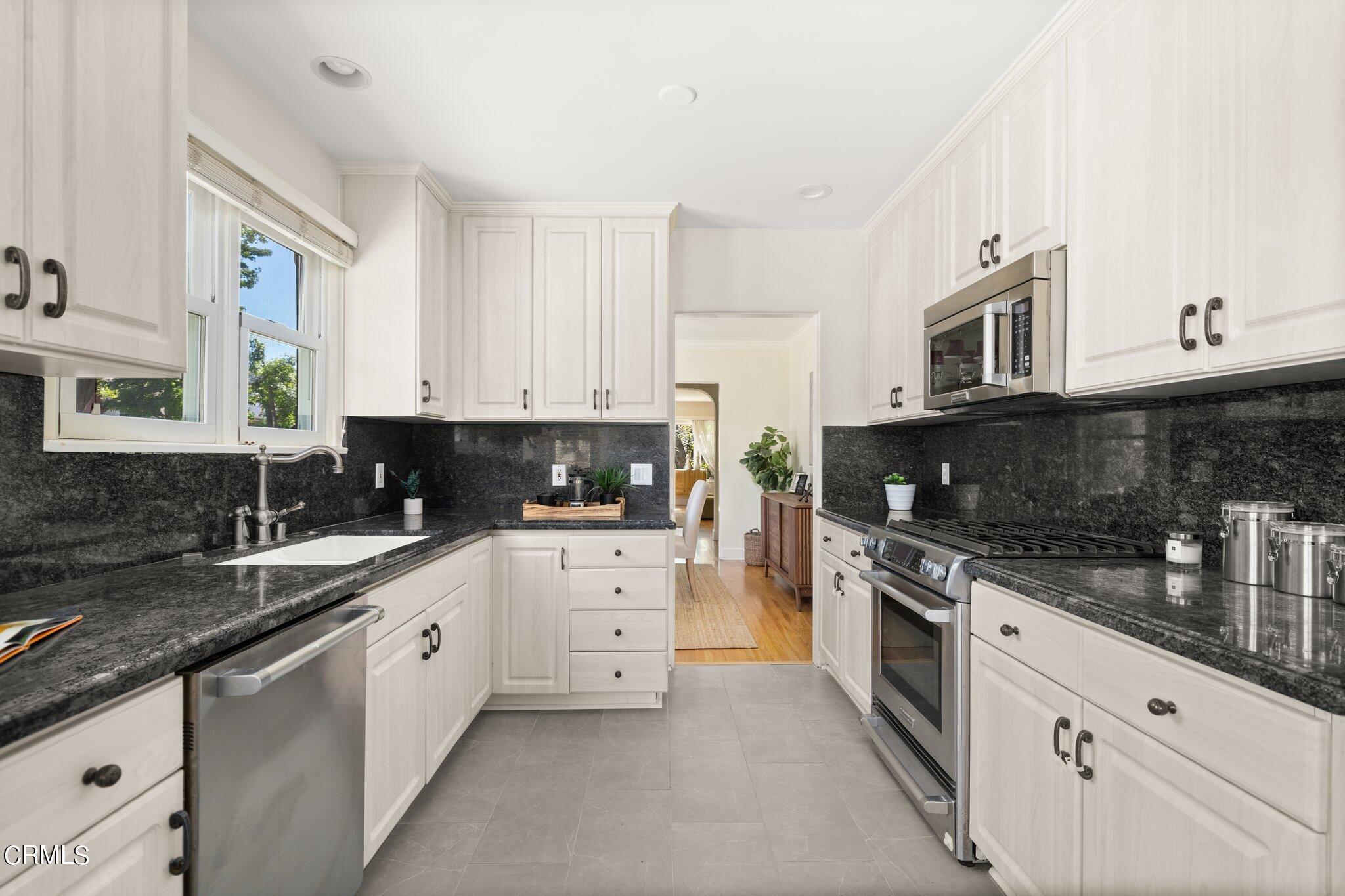 2405 Sylvan Lane Glendale, CA 91208 - Photo 13 of 43 a kitchen with stainless steel appliances granite countertop a stove a sink a refrigerator and white cabinets