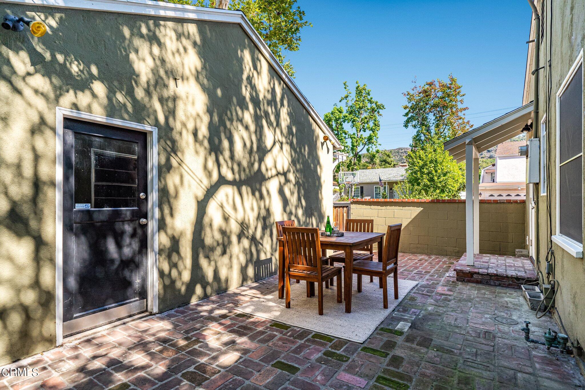 2405 Sylvan Lane Glendale, CA 91208 - Photo 32 of 43 a view of a patio with table and chairs and potted plants