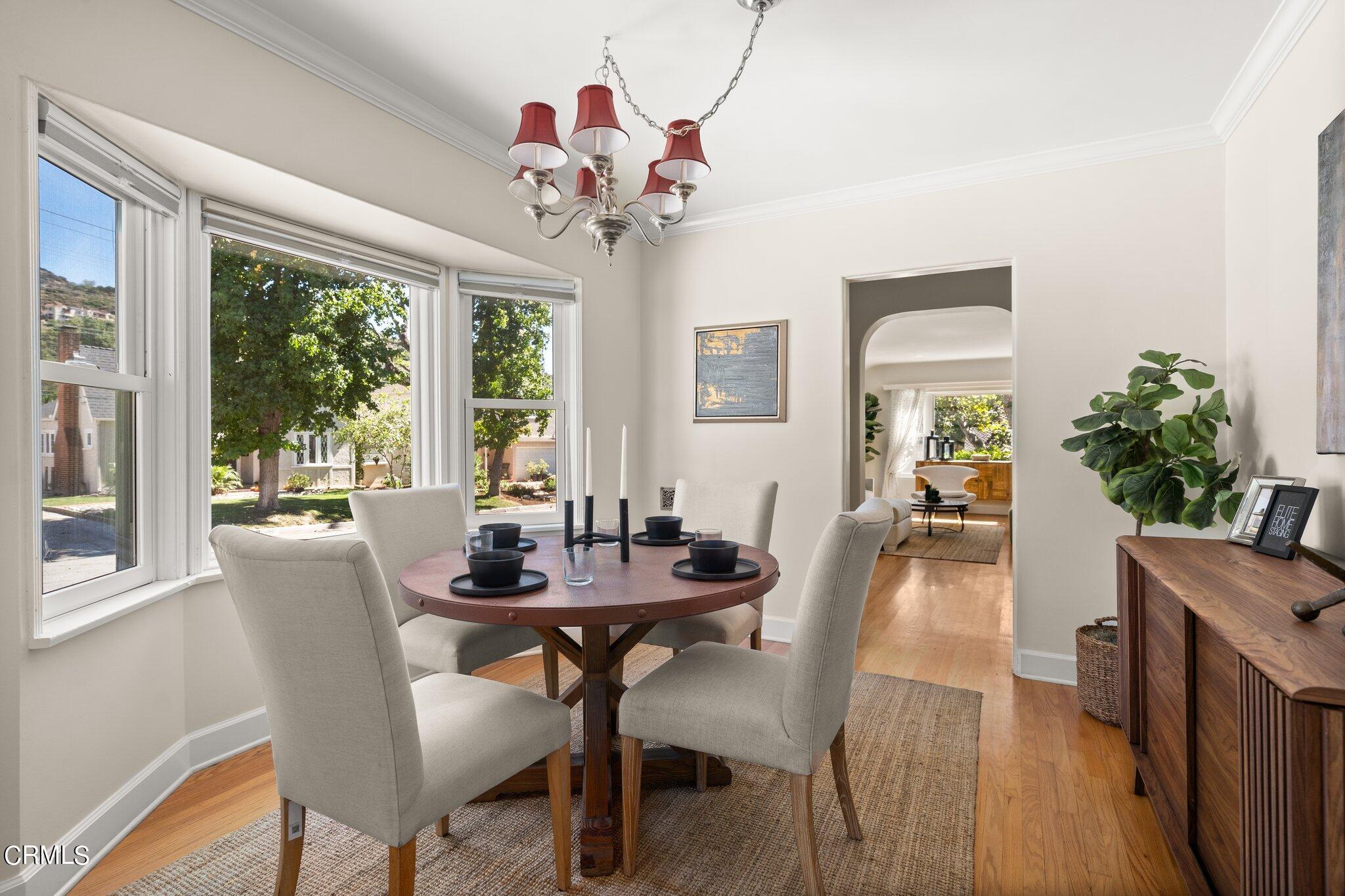 2405 Sylvan Lane Glendale, CA 91208 - Photo 8 of 43 a dining room with furniture a large window and wooden floor