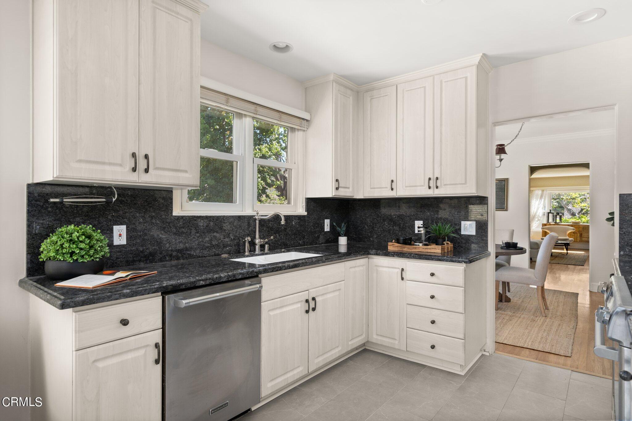 2405 Sylvan Lane Glendale, CA 91208 - Photo 10 of 43 a kitchen with granite countertop white cabinets and window