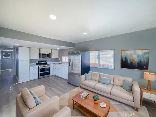 a living room with furniture and kitchen view