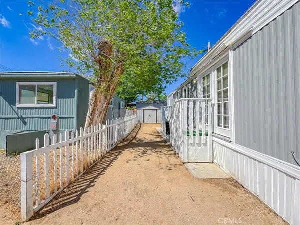 swimming view of a house with wooden fence