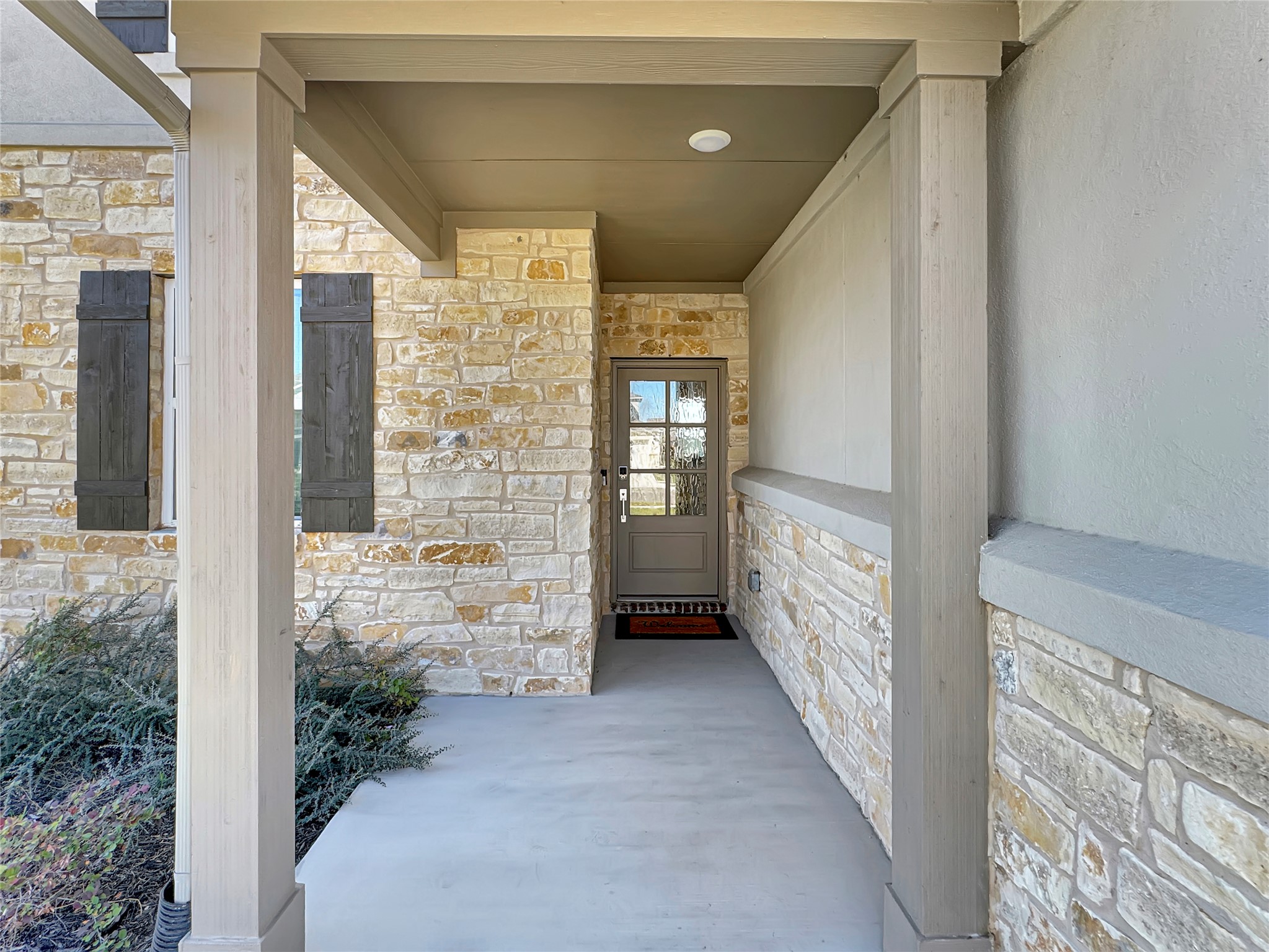 1704 Carvin Way Pflugerville, TX 78660 - Photo 2 of 30 Entrance to property featuring stone siding and covered porch