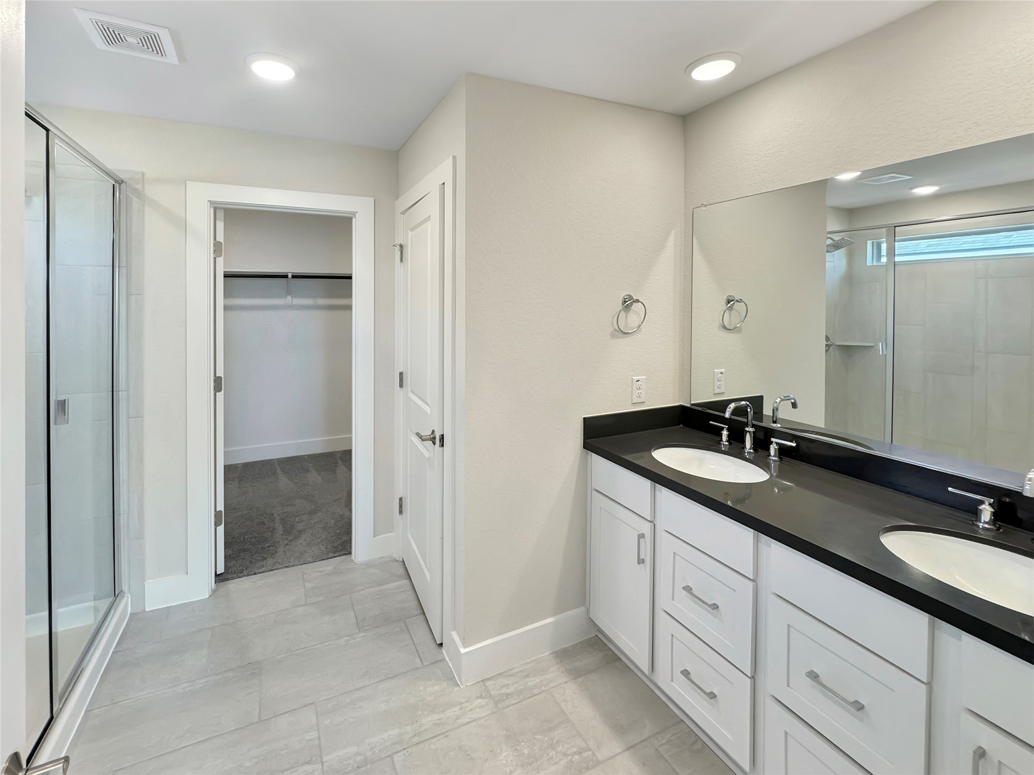 1704 Carvin Way Pflugerville, TX 78660 - Photo 21 of 30 Full bathroom with a shower stall, double vanity, and a spacious closet