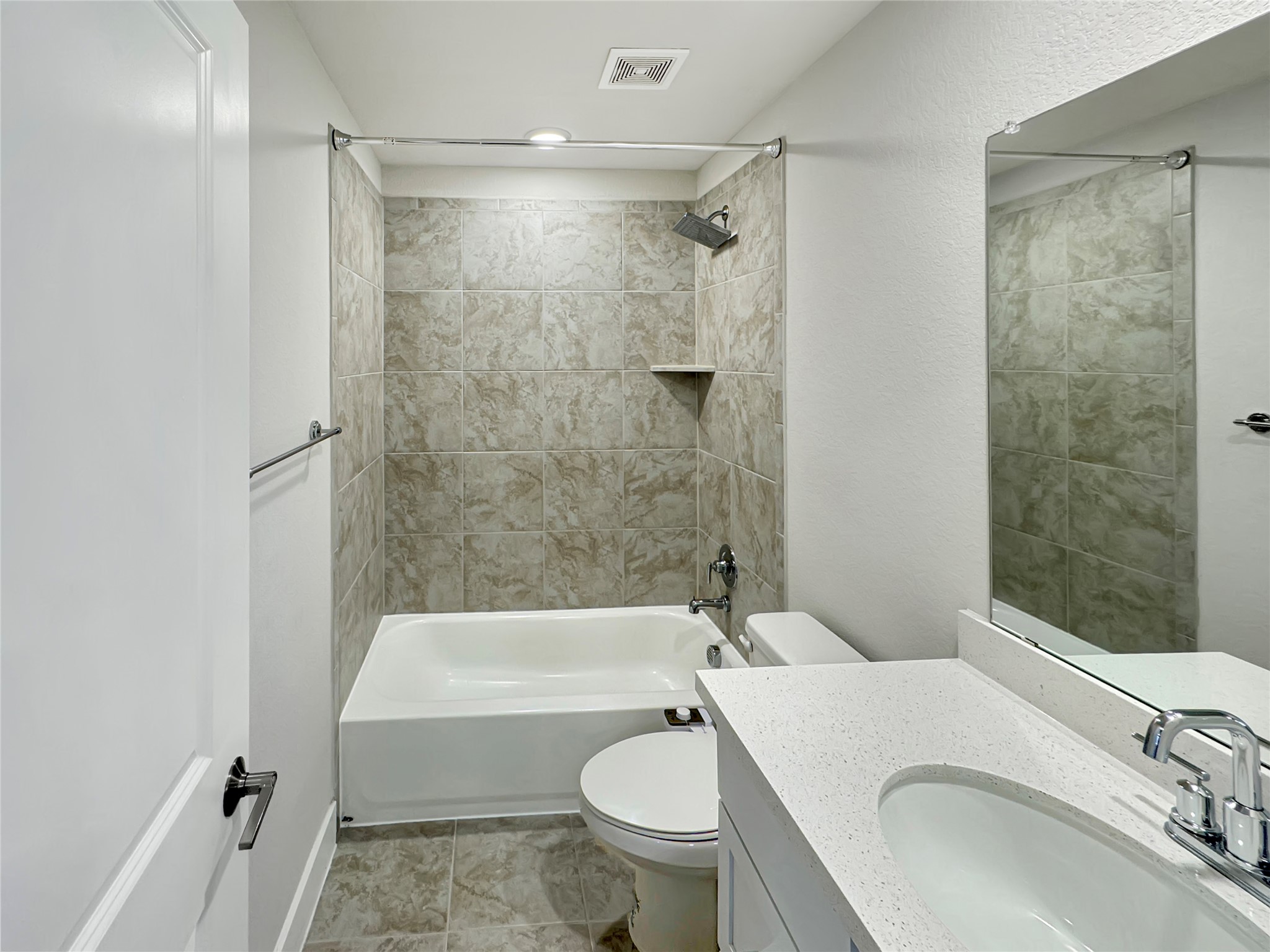 1704 Carvin Way Pflugerville, TX 78660 - Photo 25 of 30 Upstairs Full bath featuring vanity, tub / shower combination, and a textured wall