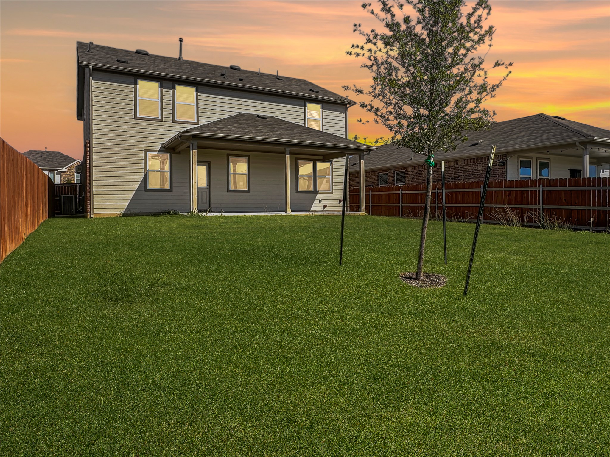 1704 Carvin Way Pflugerville, TX 78660 - Photo 28 of 30 Back of house at dusk with a patio and a fenced backyard