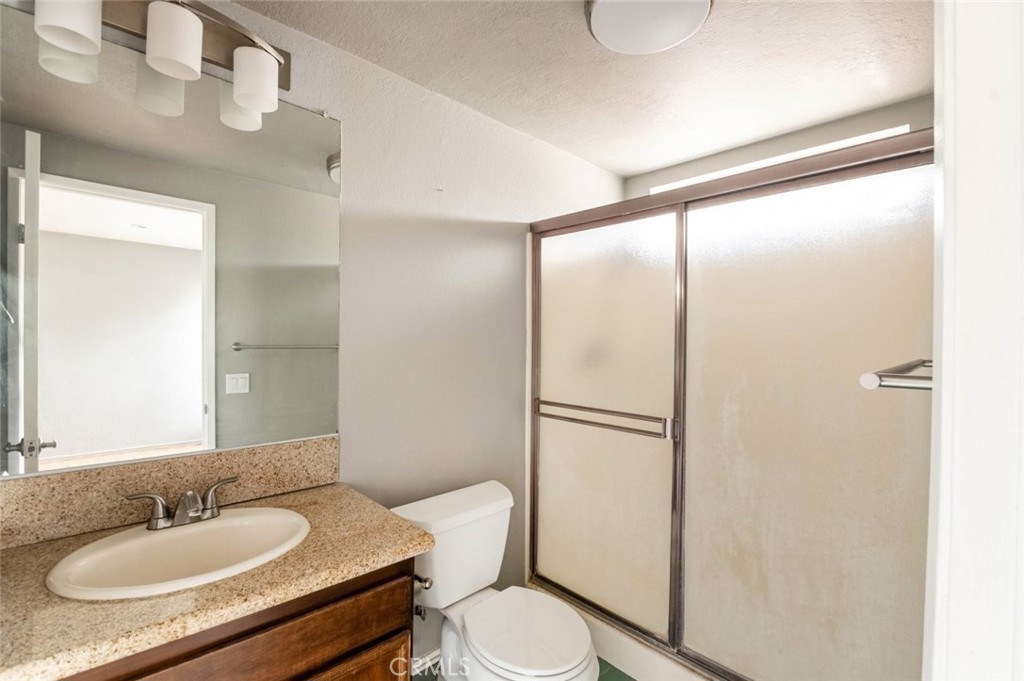 1244 Valley View Road, Unit 129 Glendale, CA 91202 - Photo 23 of 42 a bathroom with a granite countertop sink toilet and shower