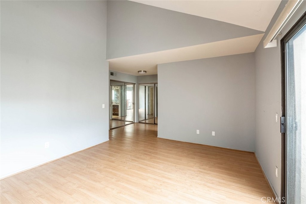 1244 Valley View Road, Unit 129 Glendale, CA 91202 - Photo 27 of 42 a view of an empty room with wooden floor and a window