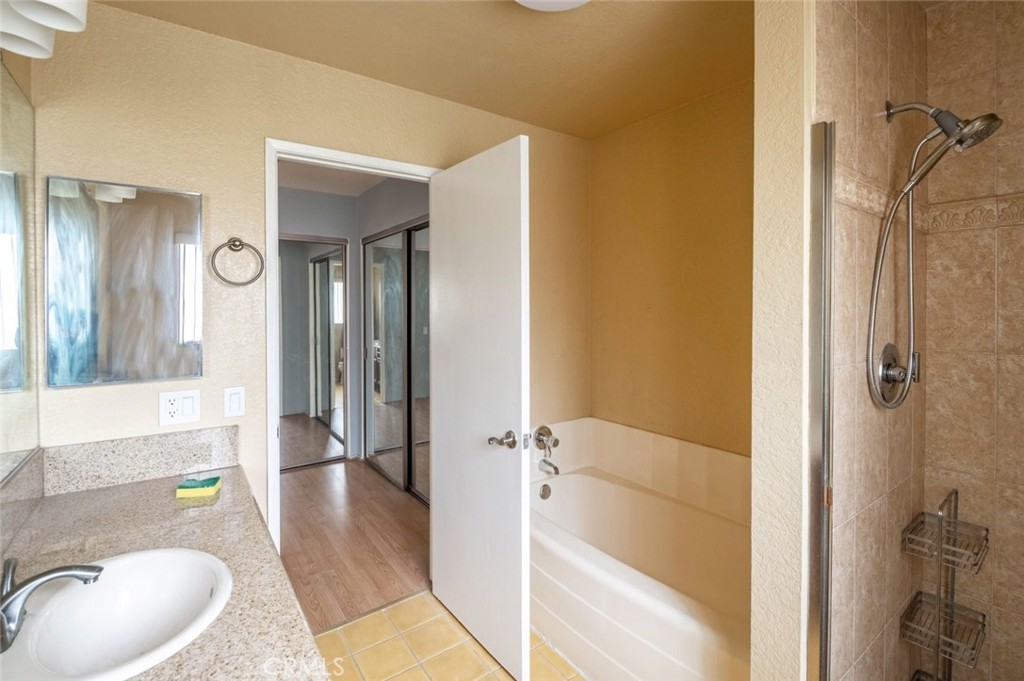 1244 Valley View Road, Unit 129 Glendale, CA 91202 - Photo 28 of 42 a bathroom with a tub shower and mirror