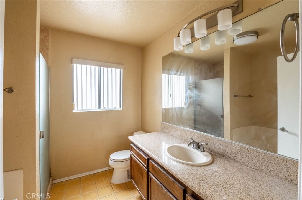 1244 Valley View Road, Unit 129 Glendale, CA 91202 - Photo 29 of 42 a bathroom with a granite countertop sink toilet and shower