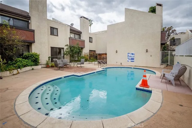 a swimming pool with outdoor seating and yard