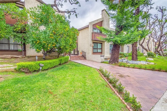 a view of a house with a yard and a patio