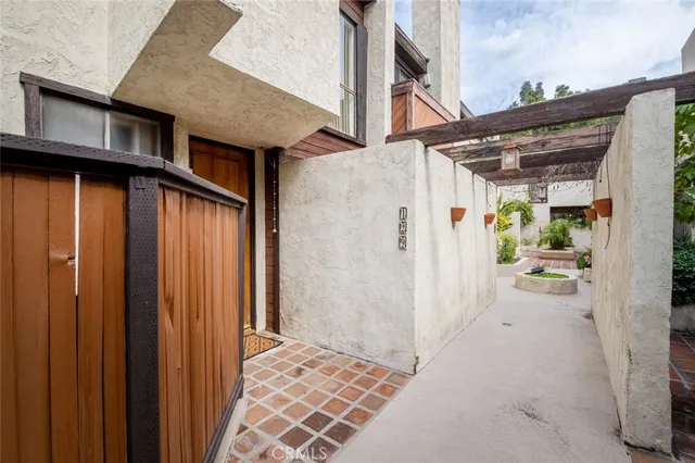 a view of a house with a wooden bench