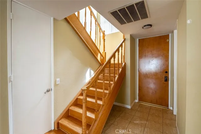 a view of empty room with wooden floor and fireplace