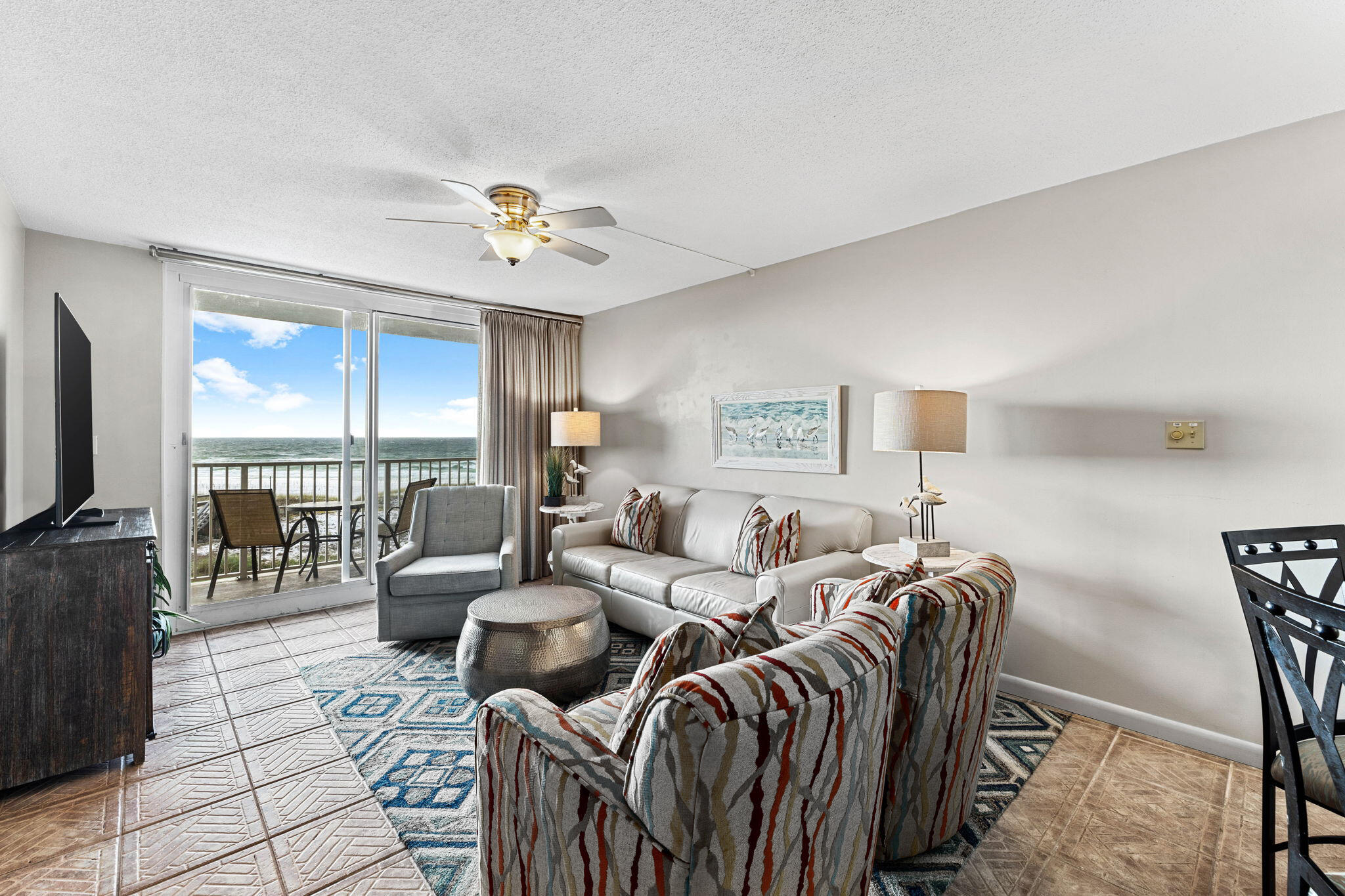 600 Gulf Shore Drive, Unit 304 Destin, FL 32541 - Photo 11 of 38 a living room with furniture a flat screen tv and a large window