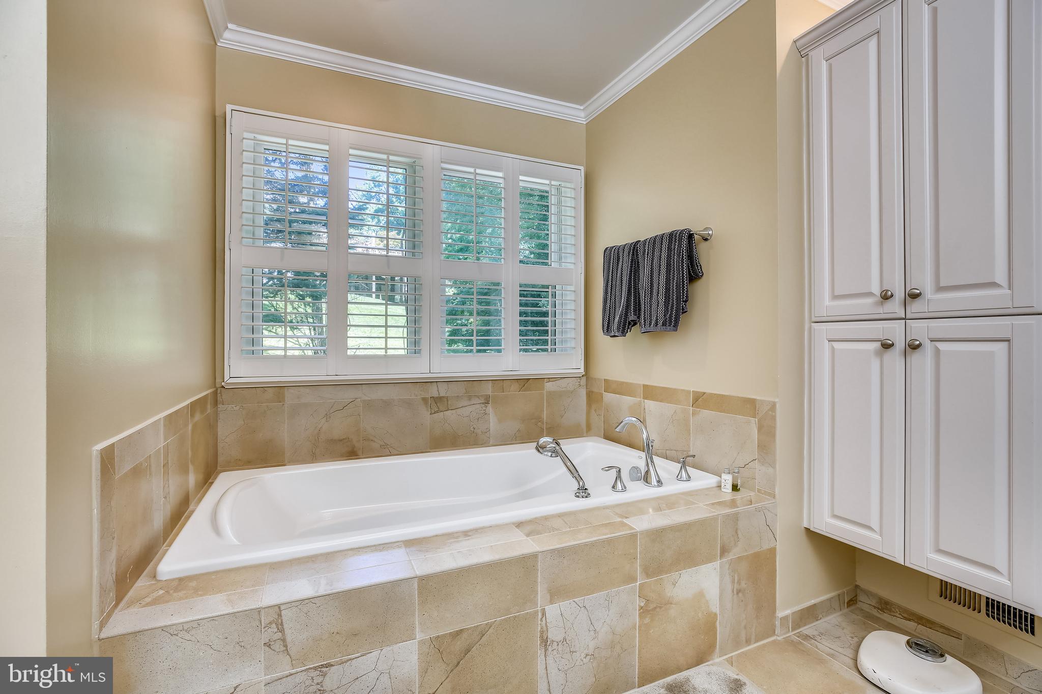 701 Kersey Road Silver Spring, MD 20902 - Photo 34 of 66 Primary bath has custom shelving and towel warmer.