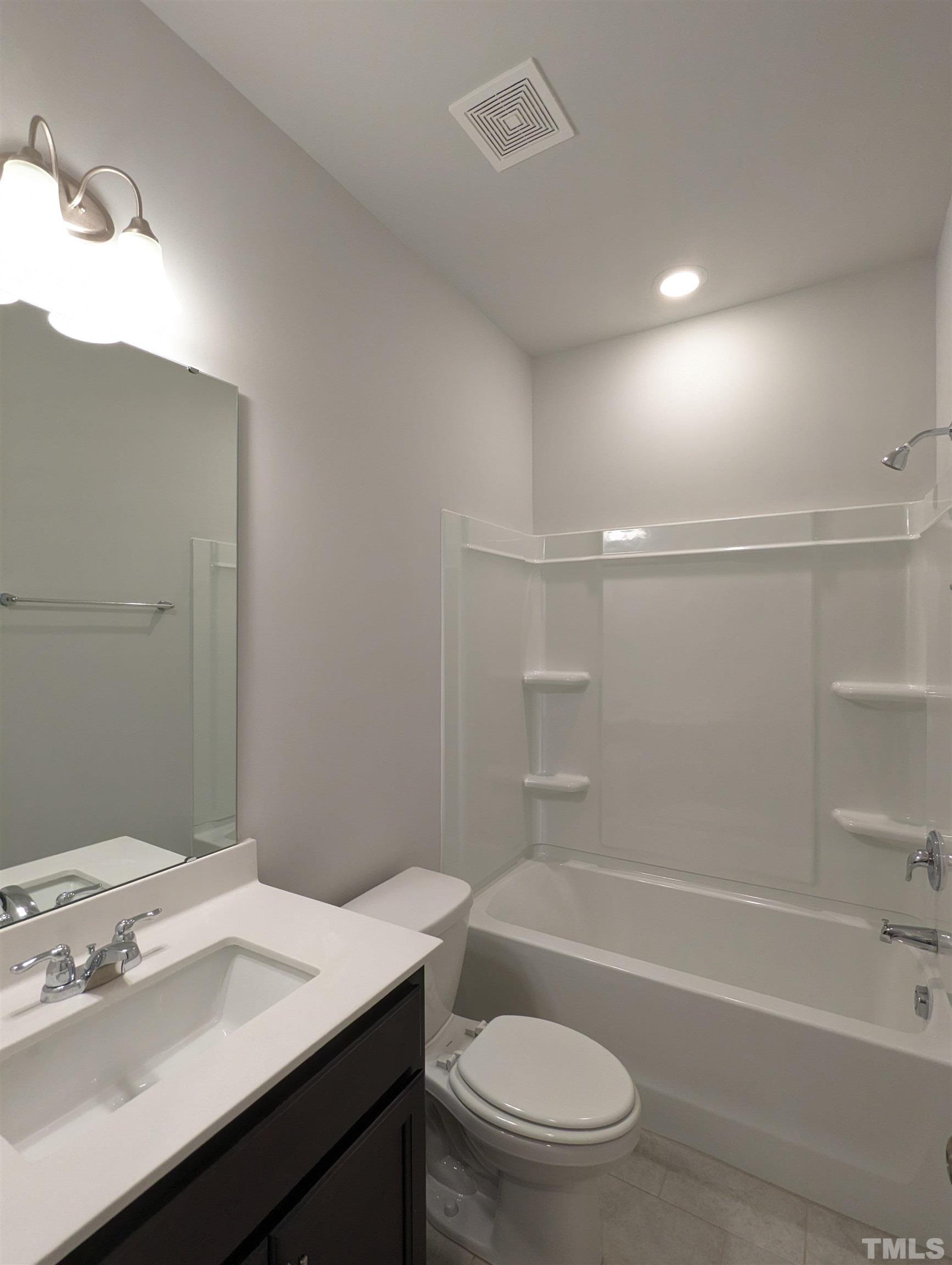604 Gimari Drive Wake Forest, NC 27587 - Photo 14 of 20 a bathroom with a sink a toilet and shower