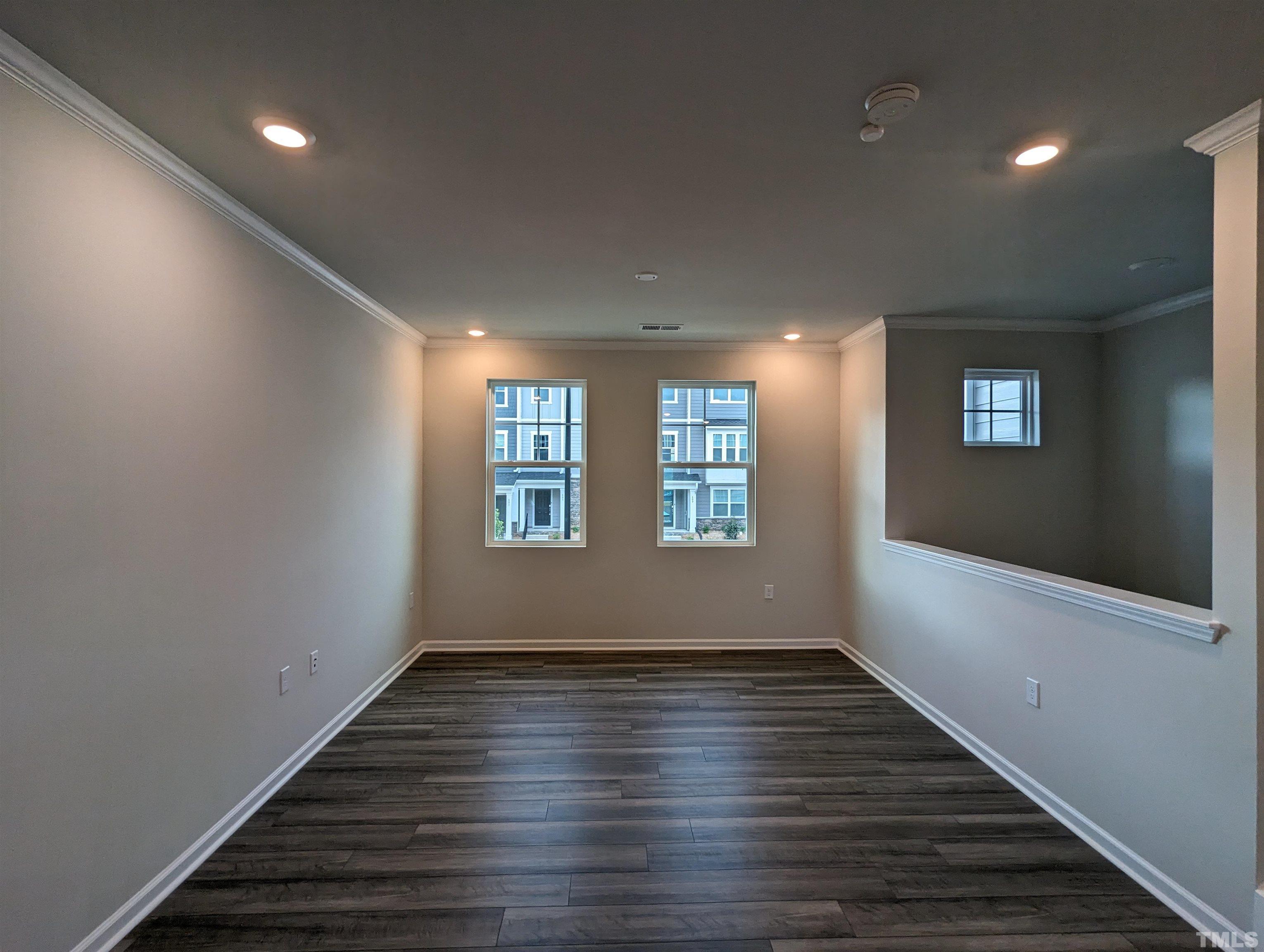 604 Gimari Drive Wake Forest, NC 27587 - Photo 4 of 20 an empty room with wooden floor and windows