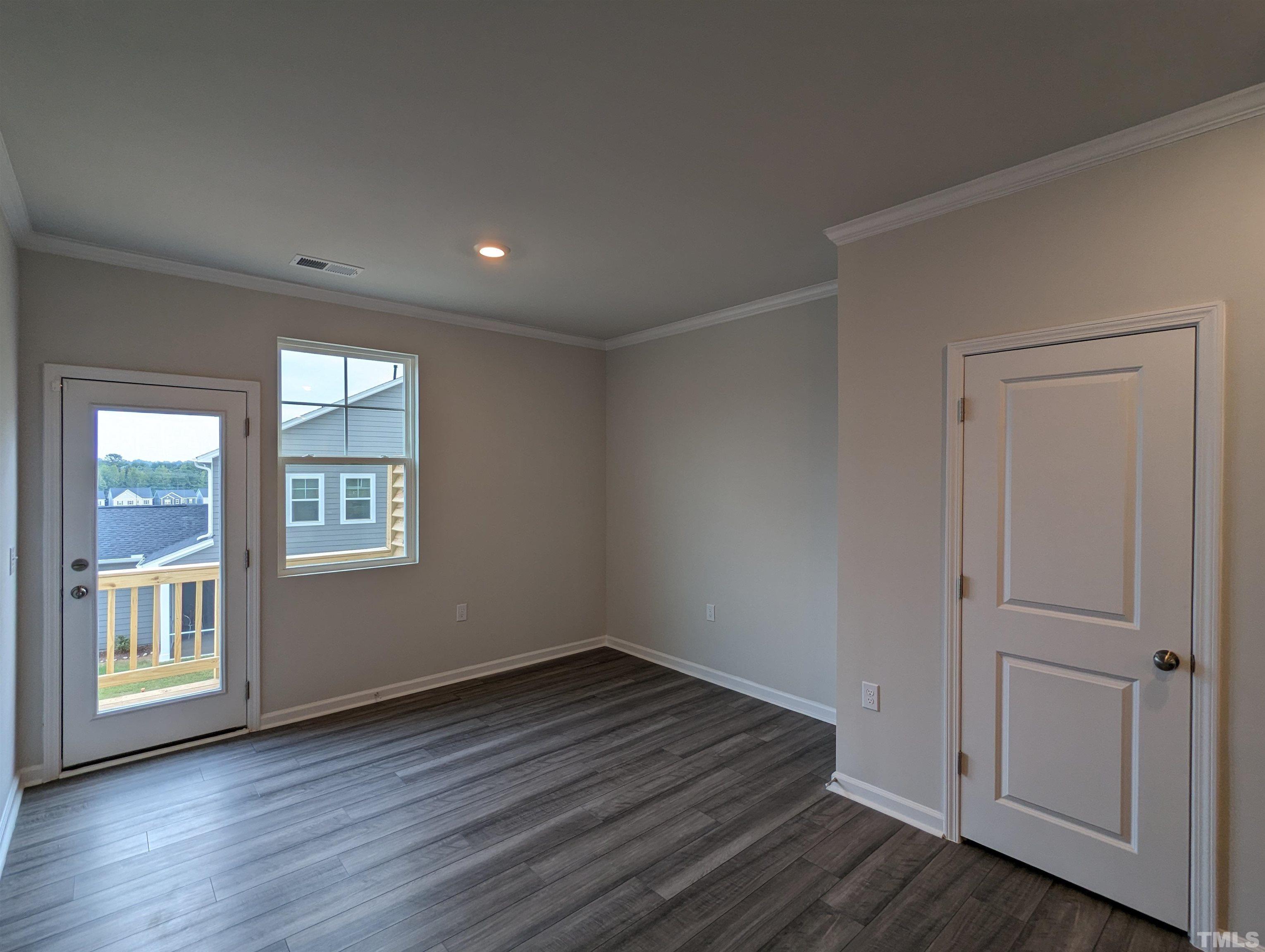 604 Gimari Drive Wake Forest, NC 27587 - Photo 5 of 20 a view of an empty room with wooden floor and a window