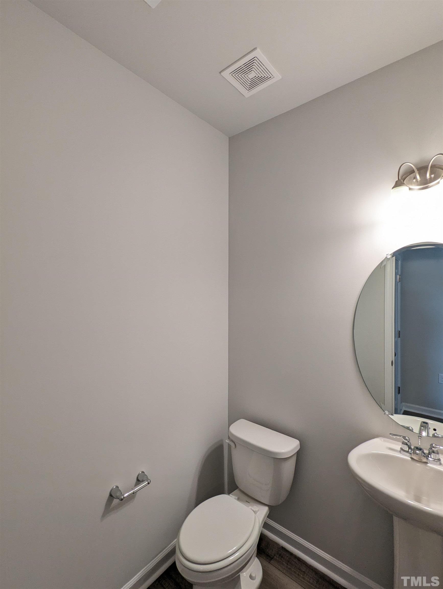 604 Gimari Drive Wake Forest, NC 27587 - Photo 7 of 20 a white toilet sitting next to a bathroom sink