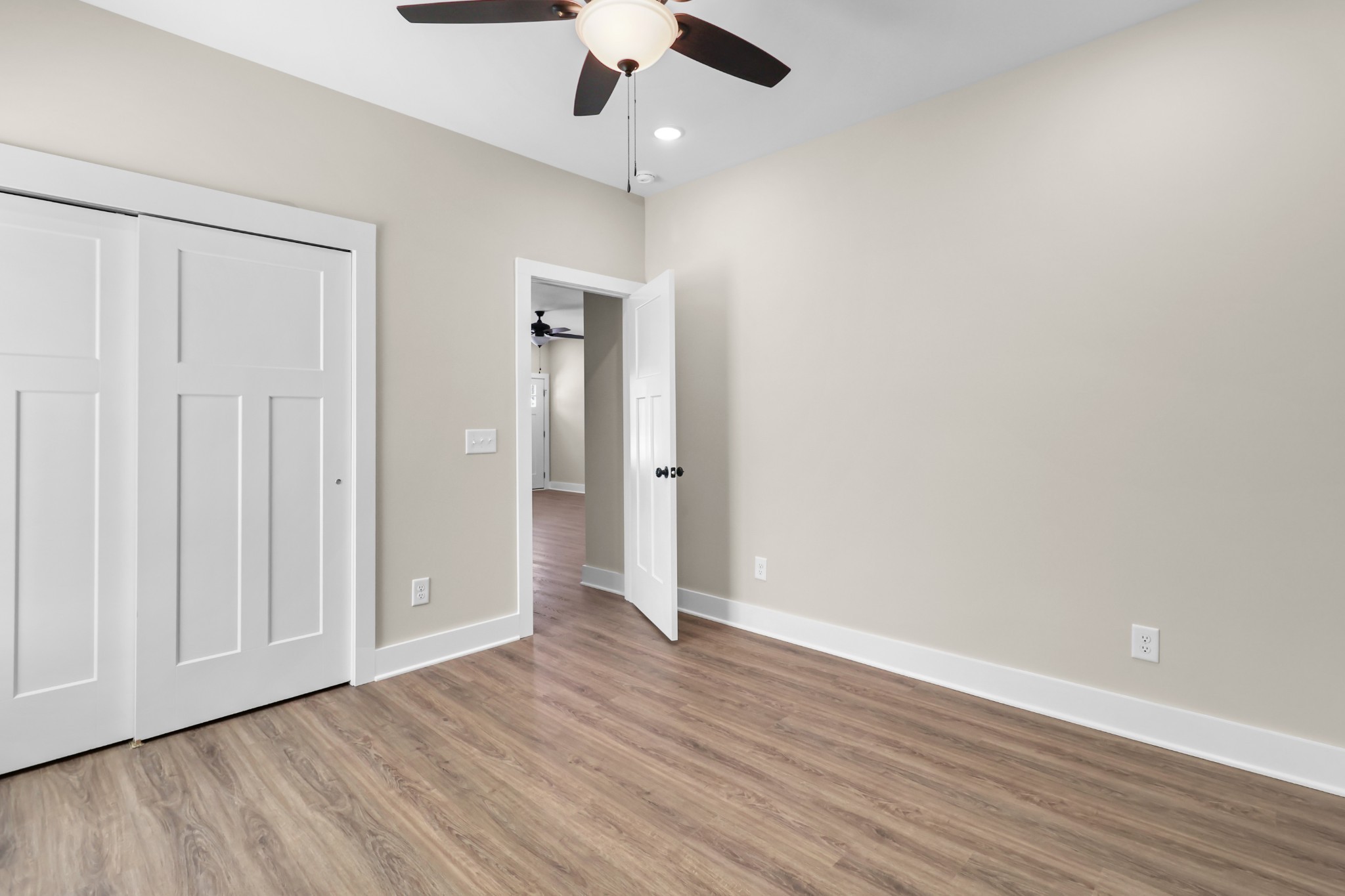 1007 Oak Street, Unit B Portland, TN 37148 - Photo 16 of 29 an empty room with wooden floor cabinet and a ceiling fan