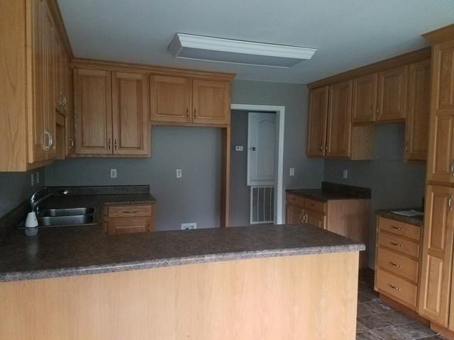 2 Grassy Branch Road Flintville, TN 37335 - Photo 4 of 13 a kitchen with stainless steel appliances granite countertop a refrigerator a stove and a sink with wooden cabinets