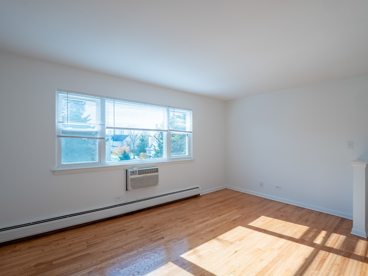 9662 Golf Terrace, Unit 2E Des Plaines, IL 60016 - Photo 11 of 24 an empty room with wooden floor and windows
