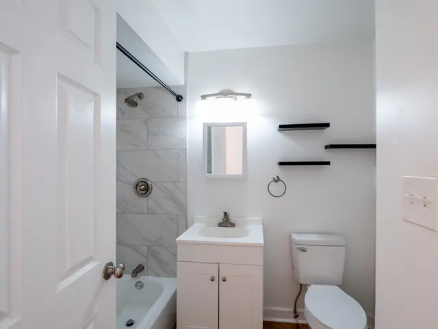 a bathroom with a toilet sink shower and mirror