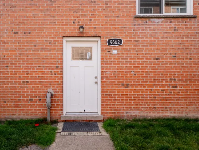 a view of a brick house with a yard
