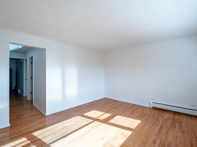 a view of a room with wooden floor