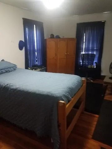 a bed sitting in a kitchen next to a cabinet