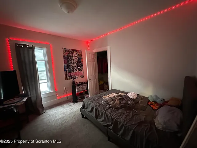 a bed sitting in a bedroom next to a window