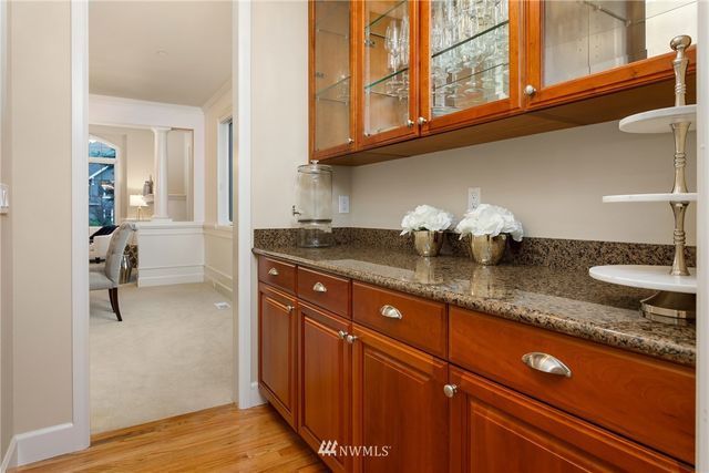 a kitchen with granite countertop stainless steel appliances a sink and cabinets