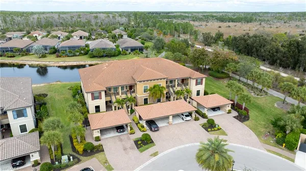 an aerial view of multiple houses with yard