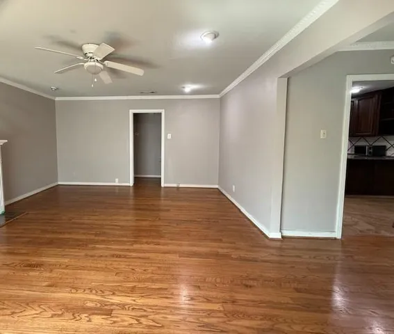 a view of an empty room and wooden floor