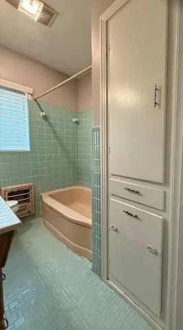 a bathroom with a tub and a shower