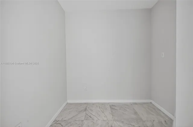 a living room with furniture and a book shelf