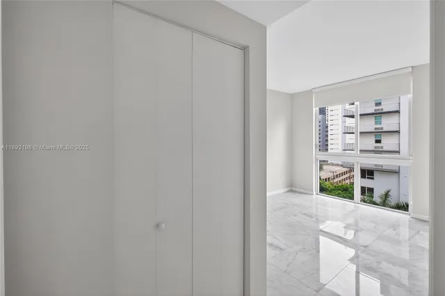 an empty room with closet and a bathroom